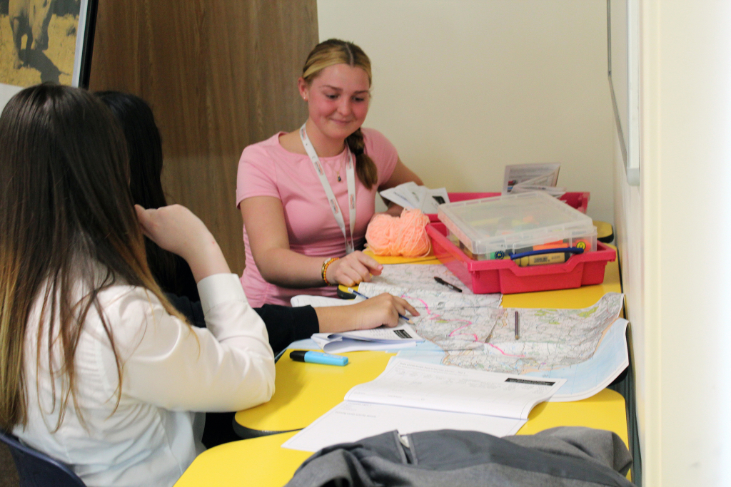 Three female Cowes Enterprise College students work on ordinance survey maps for their Duke of Edinburgh Award walks.